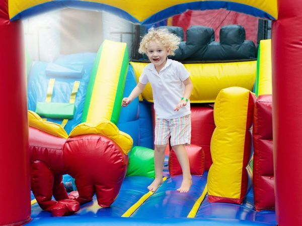 kid on inflatable slide