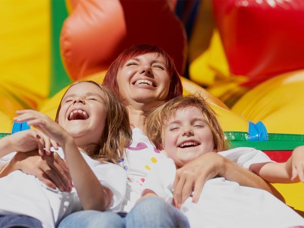 kid on inflatable slide