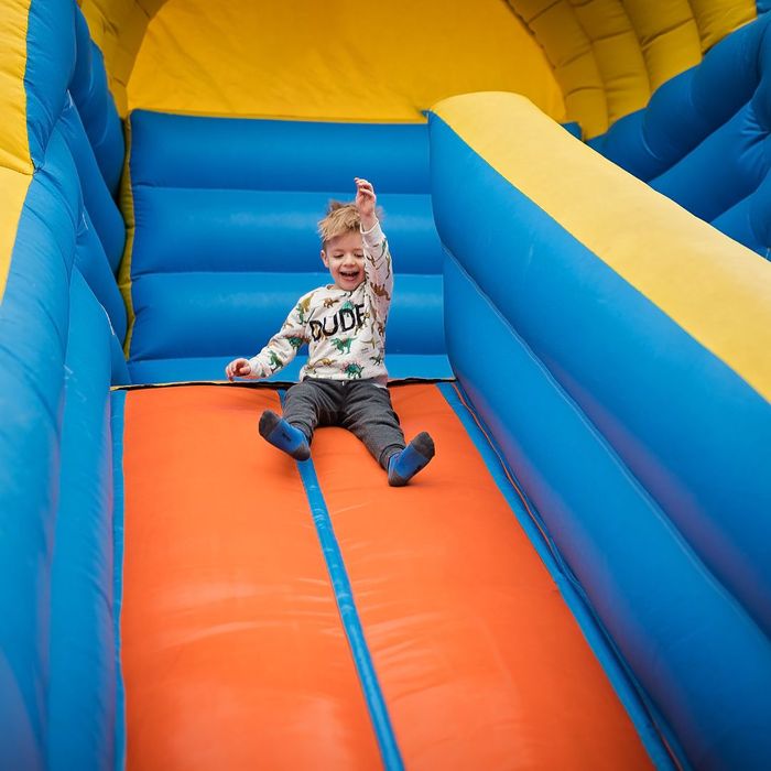 kid on inflatable slide