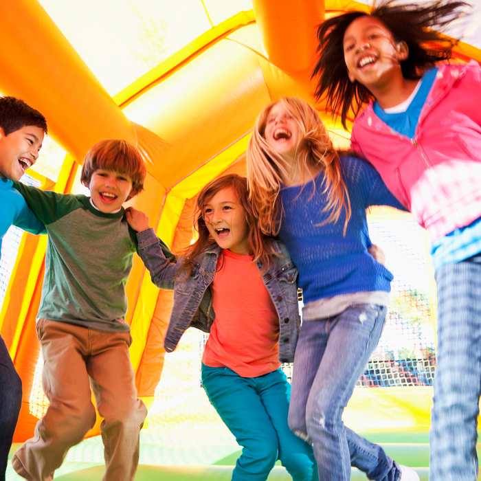 kid on inflatable slide