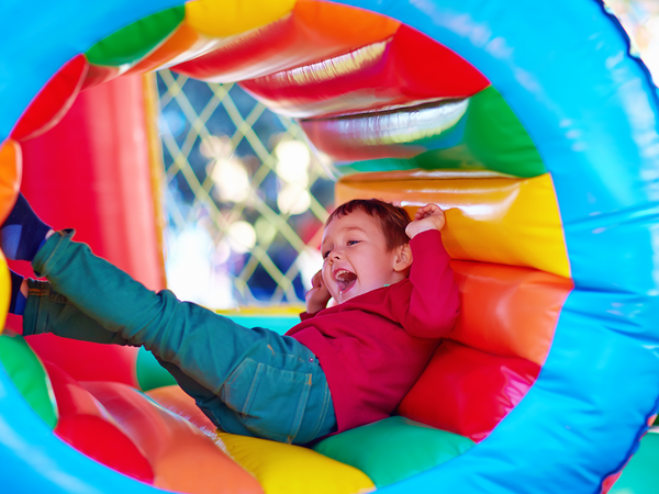 kid on inflatable slide