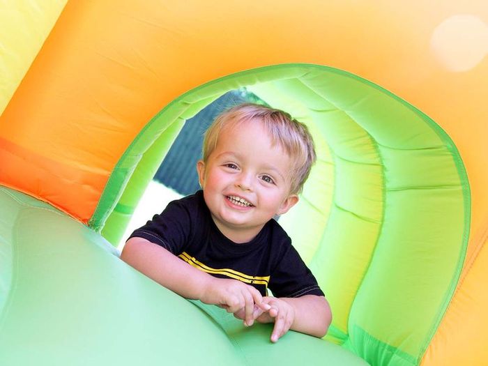 kid on inflatable slide