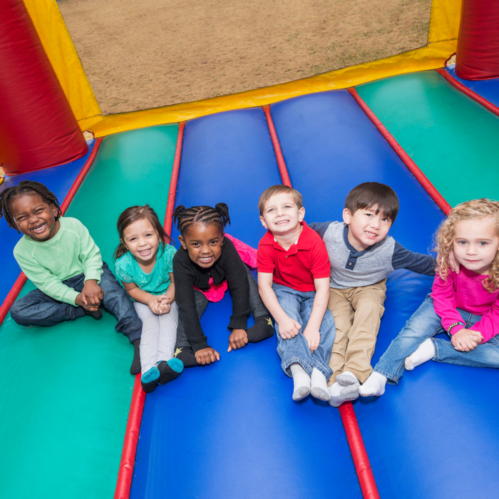 kid on inflatable slide