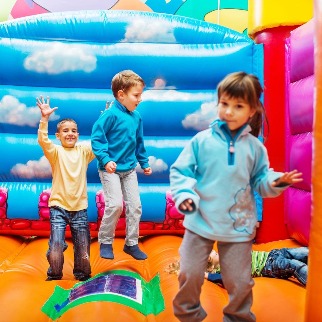 kid on inflatable slide